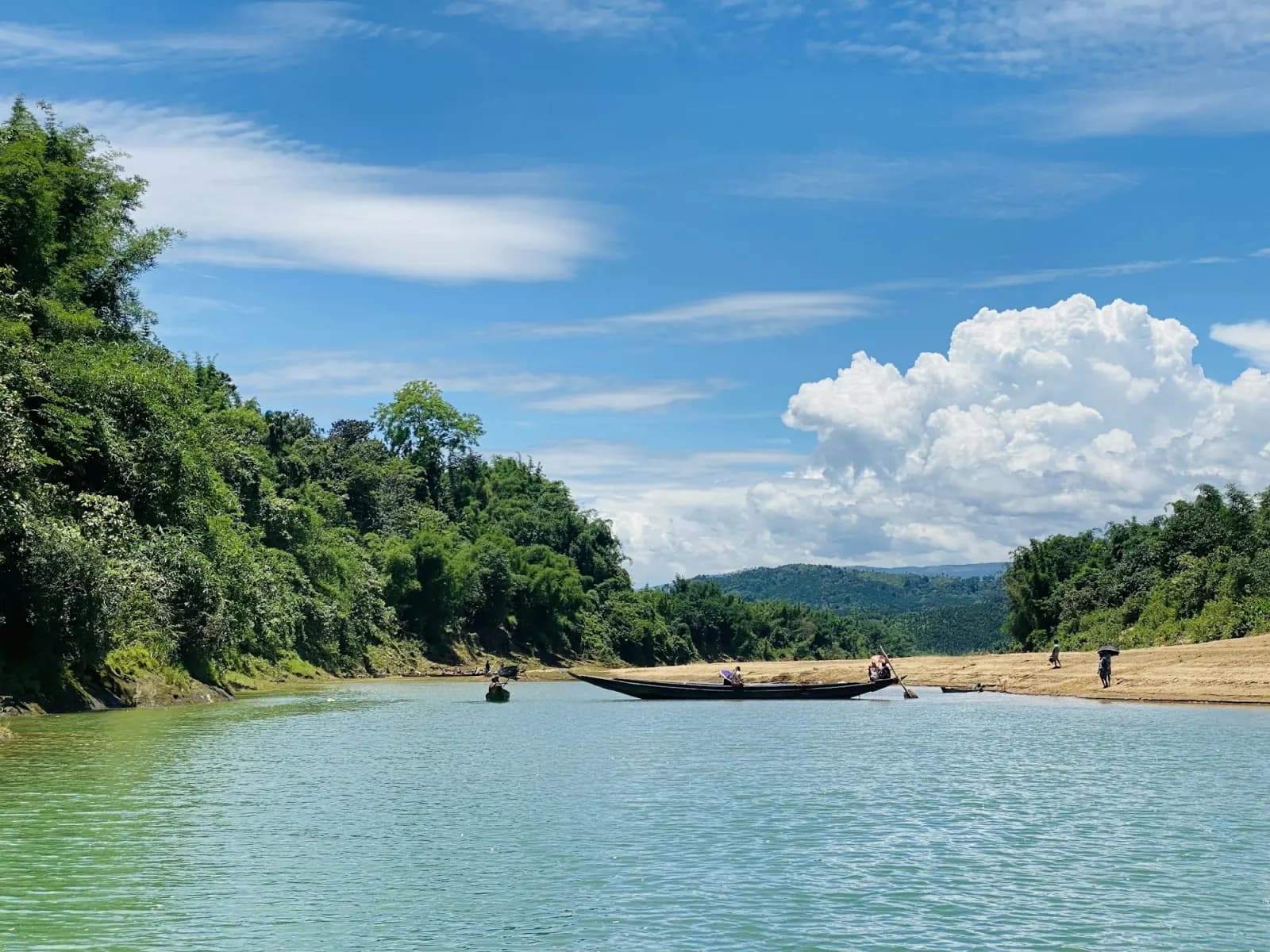 Passengers crossing a river by boat in Sylhet, Bangladesh, regional travel context for Shilaidaha Kuthibari